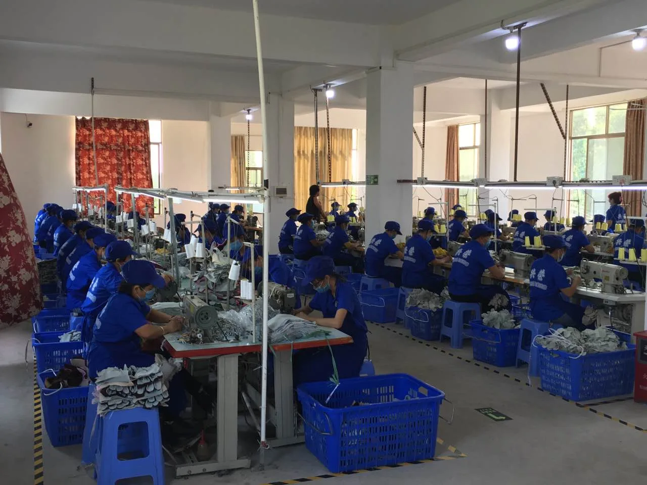 Workers sewing and finishing protective work gloves