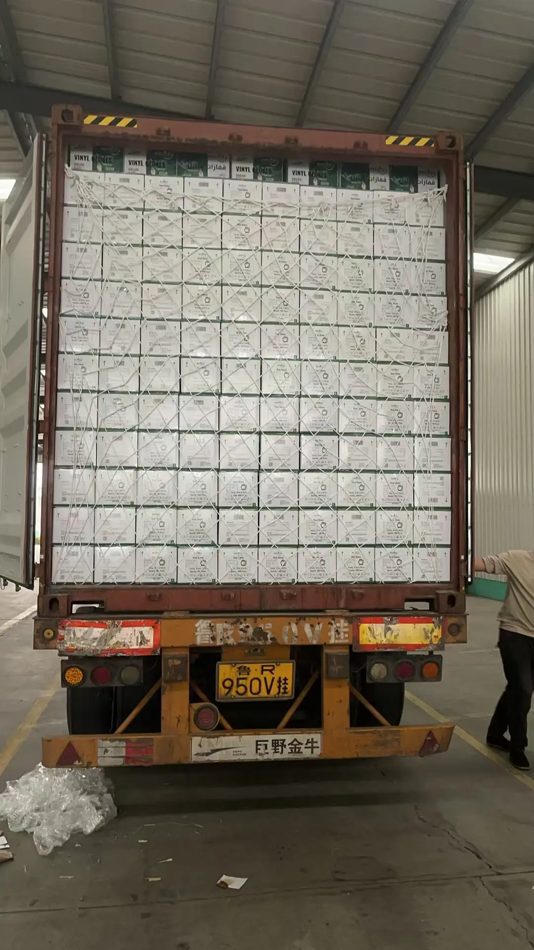Vinyl glove cartons secured inside an export container