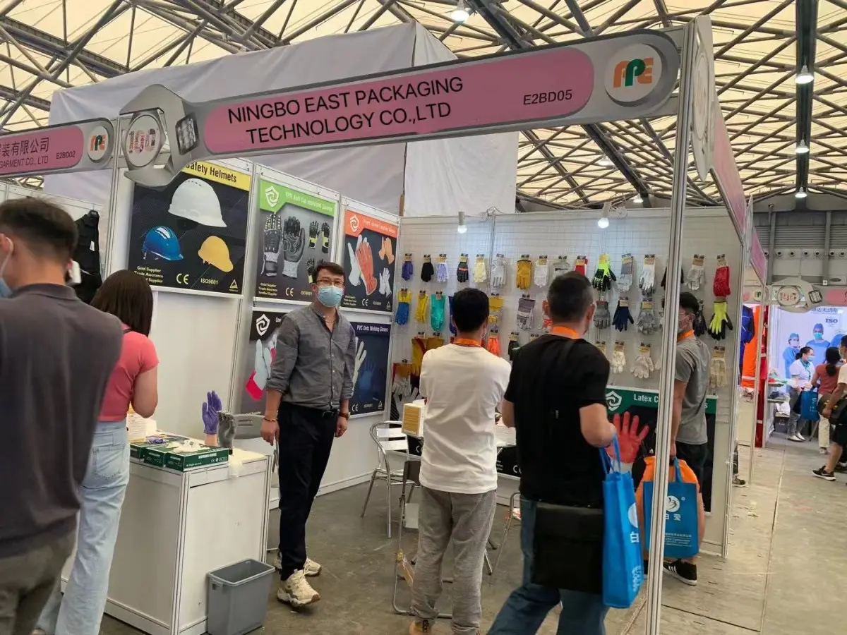 Visitors discussing glove products at the Ningbo East Packaging booth